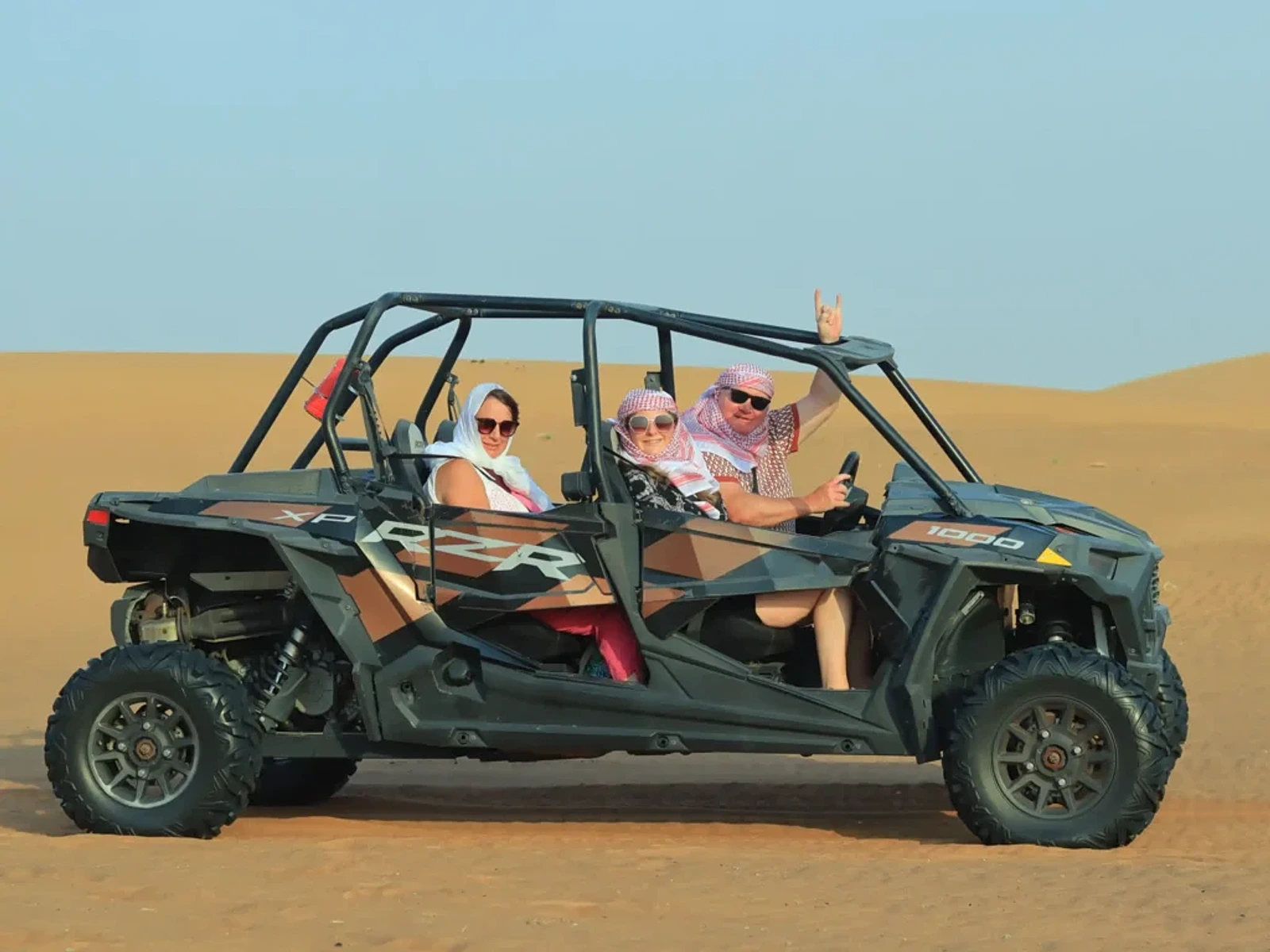 4 Seater Polaris RZR 1000 CC buggy descending a Dubai dune
