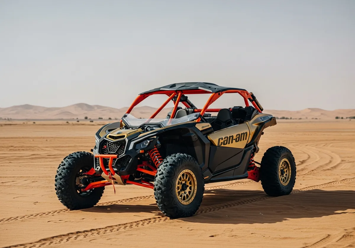Gold and black 2 Seater Can-Am Maverick X3 buggy parked in the Dubai desert
