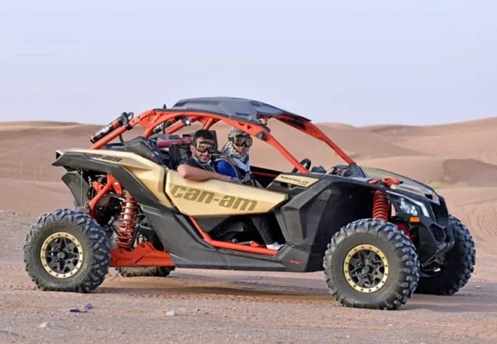 Riders in the 2 Seater Can-Am Maverick X3 buggy in the Dubai desert